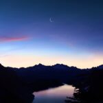 birds eye-view of lake under crescent moon