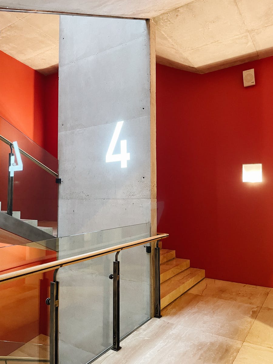 Illuminated number four on concrete wall in a modern museum staircase, Sankt-Peterburg.