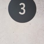 a black and white sign with the number three on it