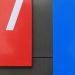 a red and blue sign with the number seven on it